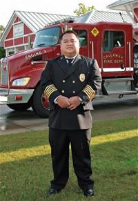 Fire Chief posing in front of Fire Department vehicle